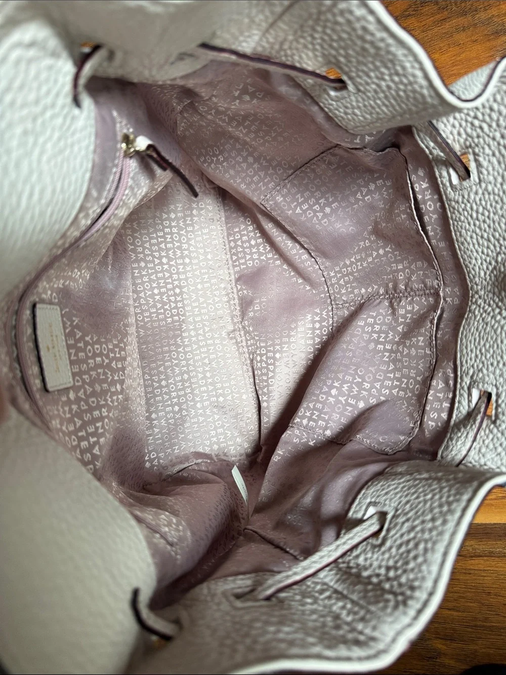 kate spade Pebbled Cream Leather Backpack with Tassel Accents